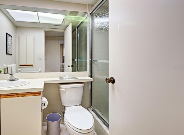 bathroom featuring vanity, tile patterned floors, toilet, and walk in shower