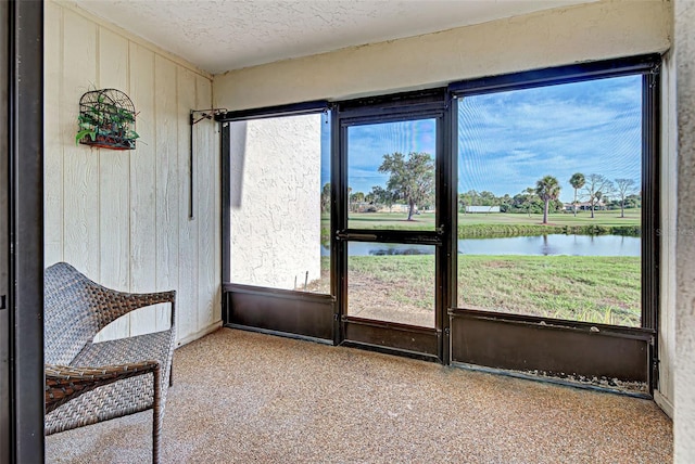 sunroom with a water view and a healthy amount of sunlight