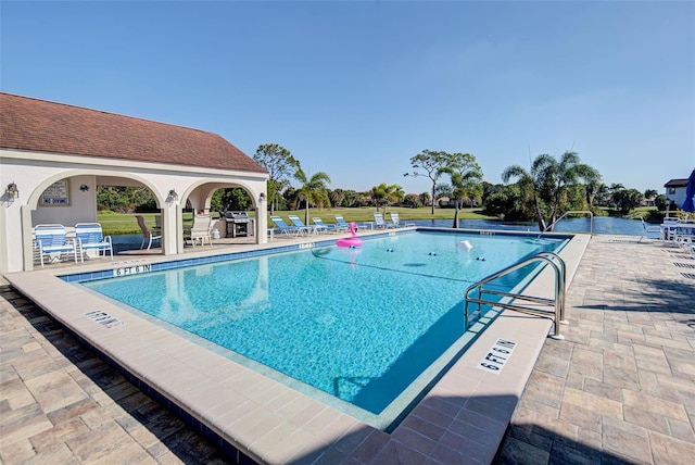 view of swimming pool featuring a patio area