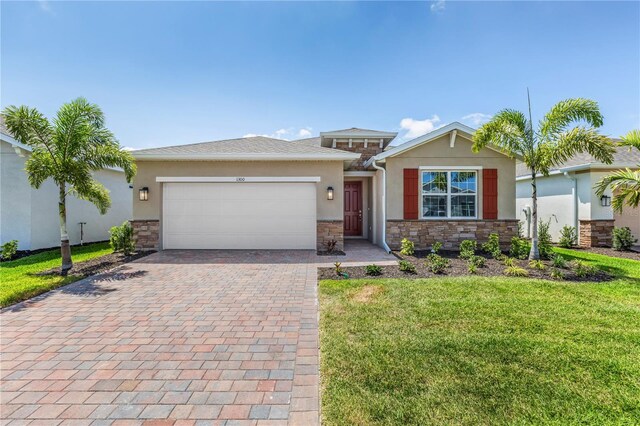 view of front of property with a front yard and a garage