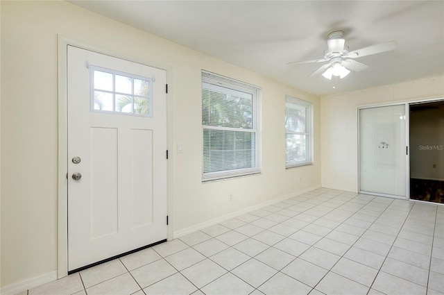 tiled foyer featuring ceiling fan