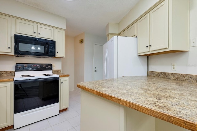 kitchen featuring white refrigerator, cream cabinetry, electric range, and light tile patterned floors