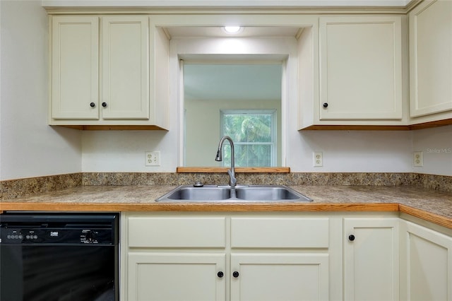 kitchen featuring sink, cream cabinetry, and black dishwasher