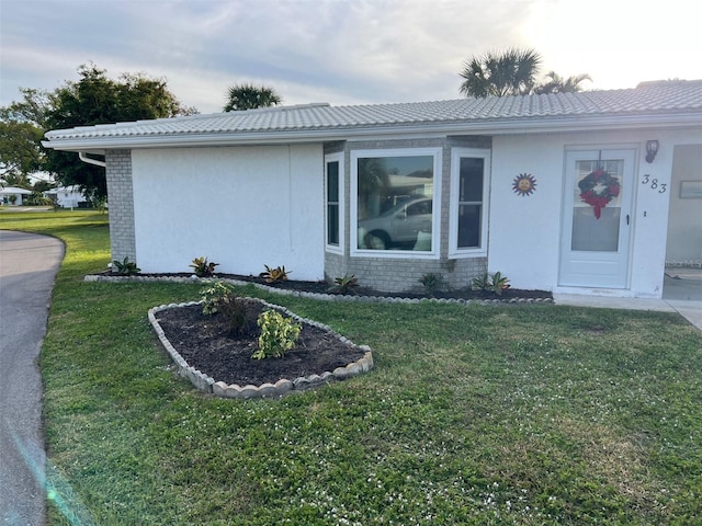 ranch-style home with a front lawn