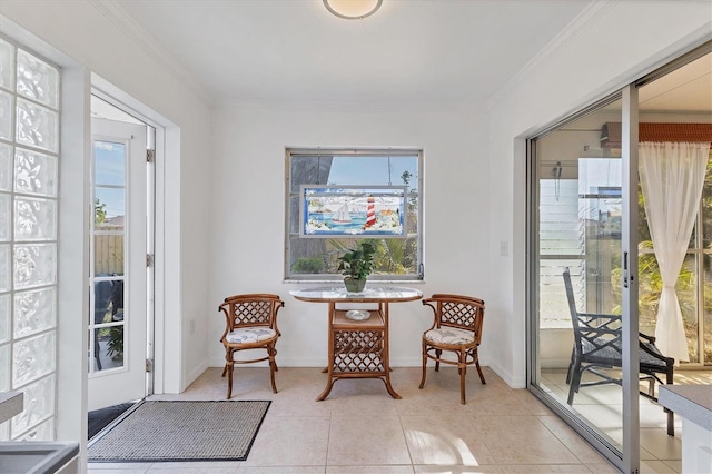 living area featuring light tile patterned flooring and ornamental molding