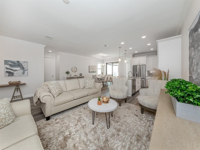 living room with ornamental molding and hardwood / wood-style flooring