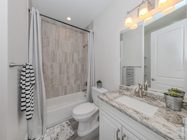 full bathroom featuring large vanity, toilet, and shower / tub combo