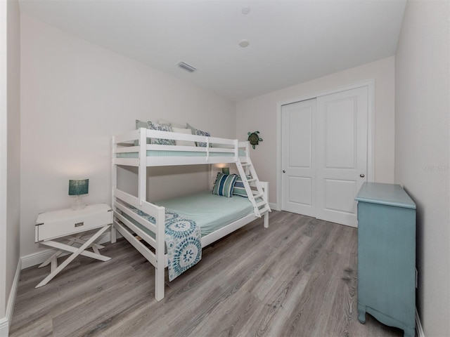 bedroom with hardwood / wood-style flooring and a closet