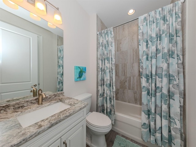 full bathroom featuring shower / bath combo with shower curtain, vanity, and toilet