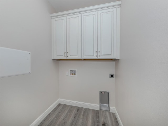 laundry room with cabinets, hookup for an electric dryer, wood-type flooring, and hookup for a washing machine