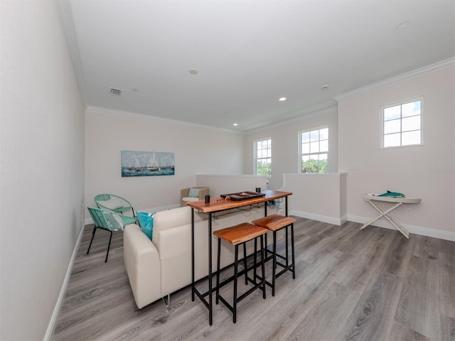 living room with wood-type flooring and ornamental molding