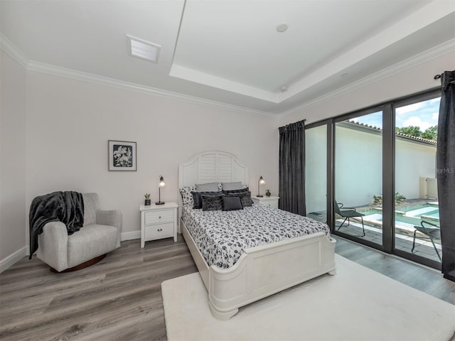 922 E Venice Ave, Venice, FL 34285 - bedroom with baseboards, access to outside, and wood finished floors