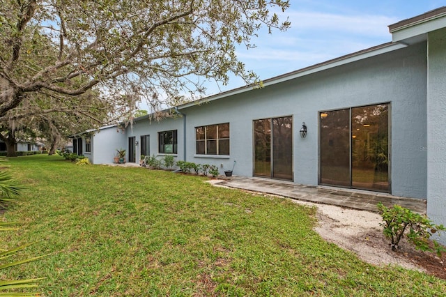 rear view of property featuring a yard