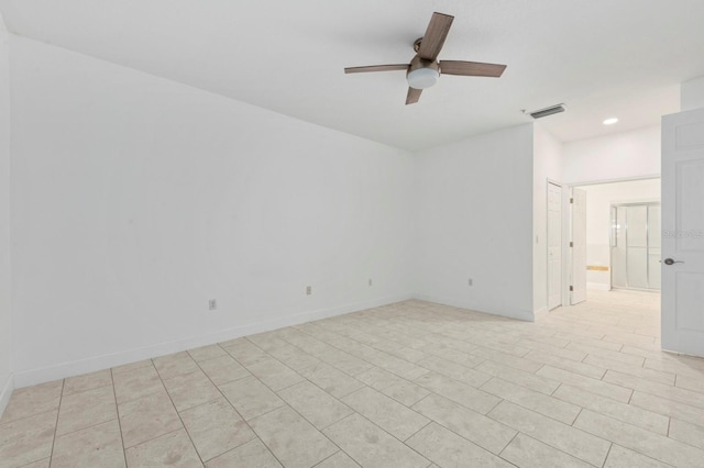 spare room featuring ceiling fan and light tile patterned floors