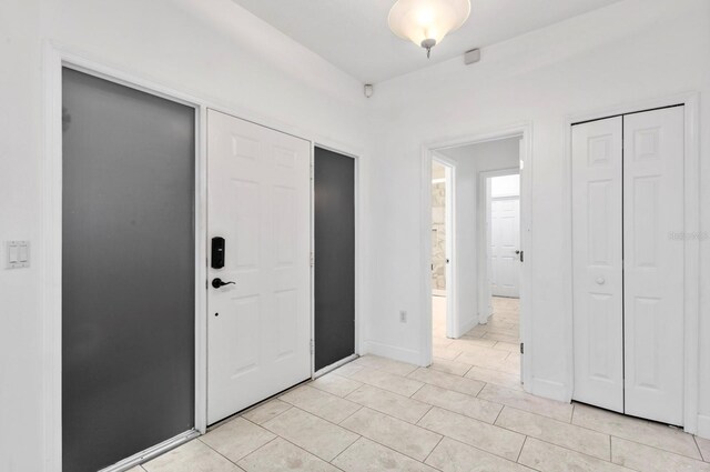 foyer entrance with light tile patterned floors