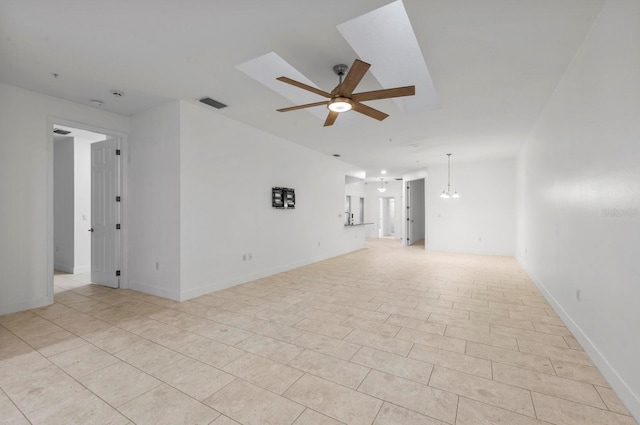 tiled spare room with ceiling fan with notable chandelier