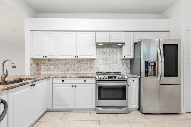 kitchen with light tile patterned flooring, sink, appliances with stainless steel finishes, and white cabinets