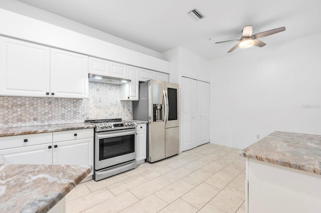 kitchen featuring appliances with stainless steel finishes, tasteful backsplash, and white cabinetry