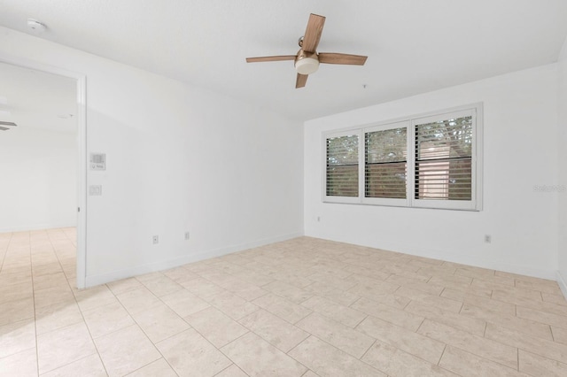 spare room featuring ceiling fan and light tile patterned floors