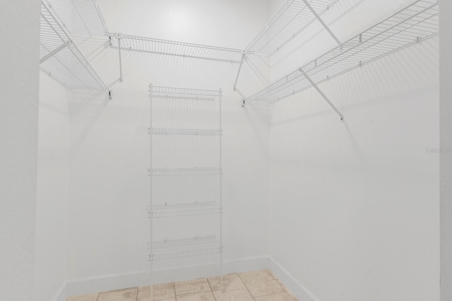 spacious closet with light tile patterned floors