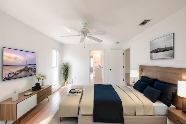 bedroom featuring light hardwood / wood-style floors, connected bathroom, and ceiling fan