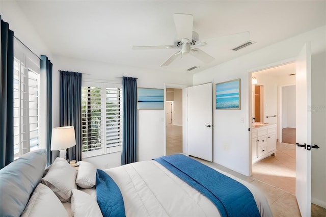 bedroom with ceiling fan, connected bathroom, light tile floors, and sink