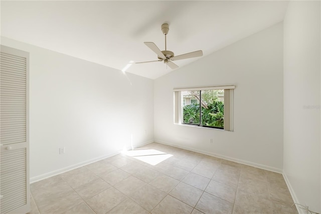 tiled spare room featuring vaulted ceiling and ceiling fan