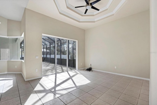 unfurnished room with light tile floors, a tray ceiling, ceiling fan, and ornamental molding