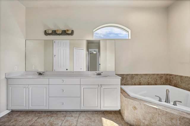 bathroom with tiled bath, dual bowl vanity, and tile flooring