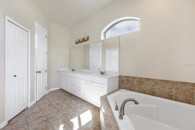 bathroom featuring tile floors, a relaxing tiled bath, and double sink vanity