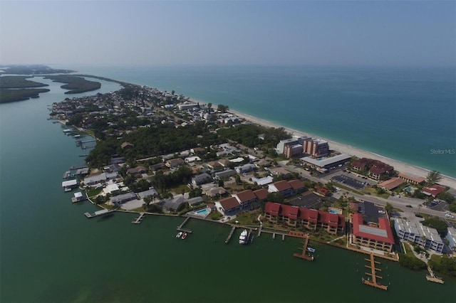 bird's eye view with a water view and a beach view