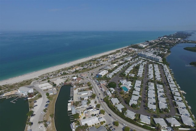 bird's eye view featuring a water view and a beach view