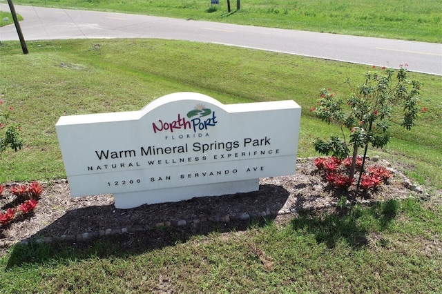 community / neighborhood sign with a lawn