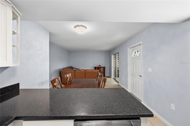 kitchen with light tile flooring and white cabinets