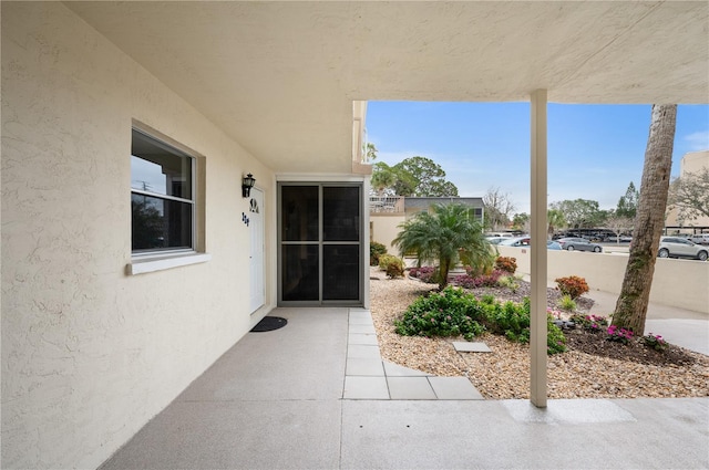 view of exterior entry featuring a patio