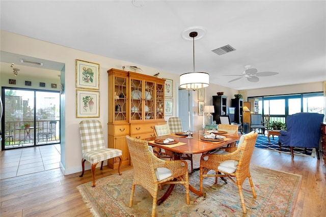 dining space featuring ceiling fan and light wood-type flooring