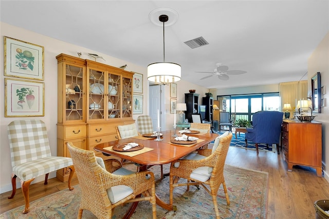 dining room featuring light hardwood / wood-style floors and ceiling fan