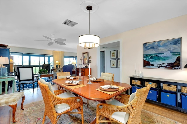 dining area with ceiling fan and light hardwood / wood-style flooring