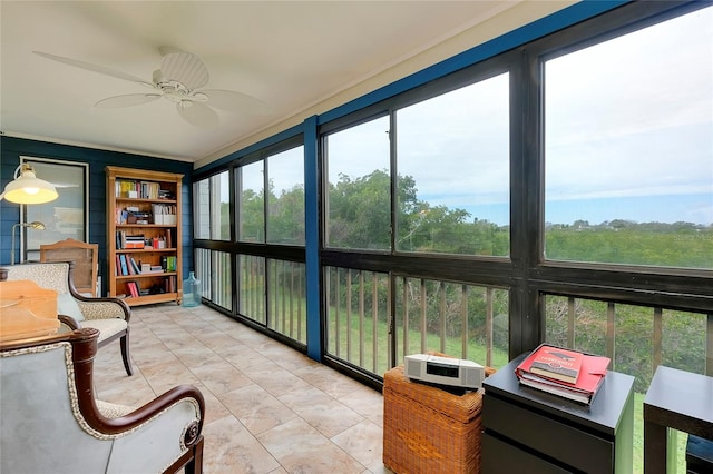 sunroom / solarium with a healthy amount of sunlight and ceiling fan