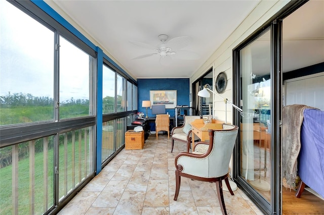 sunroom featuring ceiling fan