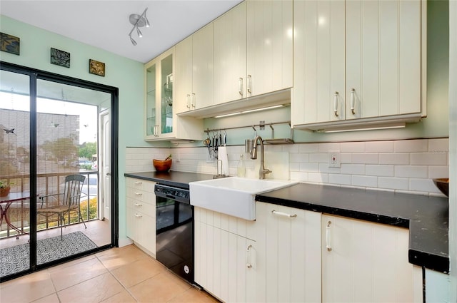 kitchen with sink, light tile floors, white cabinets, dishwasher, and tasteful backsplash