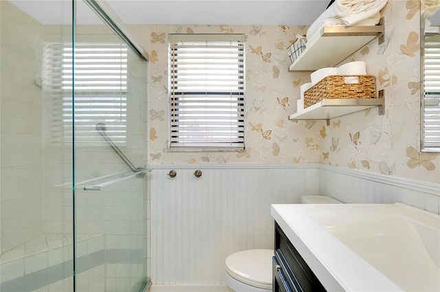 bathroom with an enclosed shower, toilet, and vanity