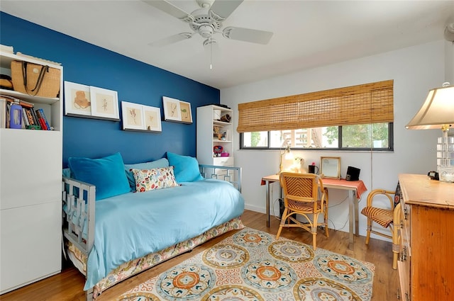 bedroom featuring hardwood / wood-style floors and ceiling fan