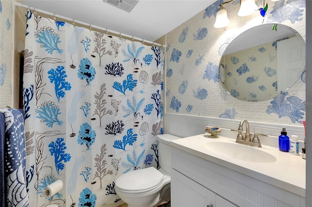 bathroom with toilet and vanity