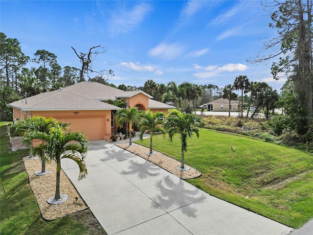 view of front of property with a front yard and a garage