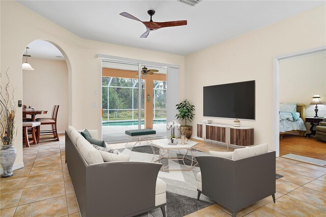 tiled living room featuring ceiling fan