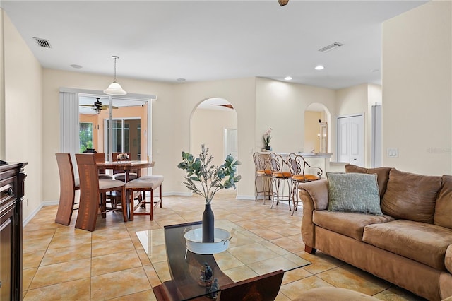 tiled living room with ceiling fan