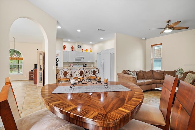 dining room featuring light tile floors and ceiling fan