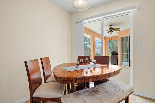 dining space featuring ceiling fan and light tile floors