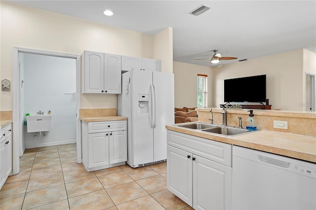 kitchen with light tile flooring, ceiling fan, white appliances, white cabinets, and sink